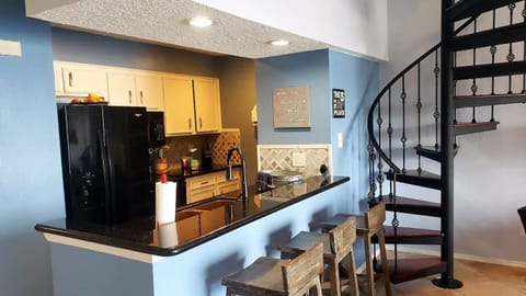 Bar seating and kitchen.