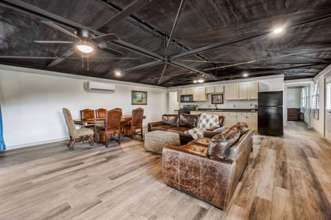 The living room is designed for relaxation with comfortable leather furniture and plenty of space. With smart TVs in every room, it’s easy to unwind after a day spent outdoors.