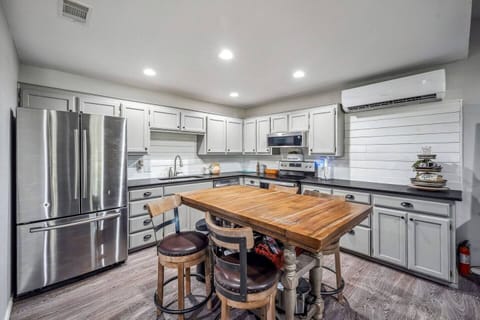 The large kitchen is fully equipped with modern appliances and a kitchen island, offering plenty of space for cooking and meal prep. Whether you're cooking for a family dinner or preparing a quick snack, this kitchen has everything you need.