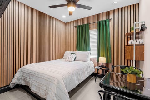 This cozy studio offers a queen-size bed with a simple yet inviting design. The space also features a small dining table for two, making it a perfect spot for a quick meal or work.
