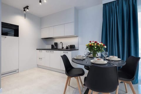 Large table with chairs for eating communal meals.