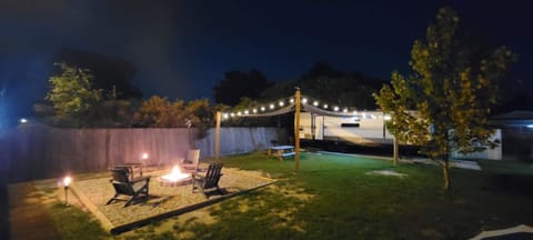 Grill dinner for outdoor dining under bistro lighting.