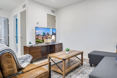 Bright and airy living room with plush seating, a large TV, and tasteful decor, creating the perfect space for relaxation and entertainment.