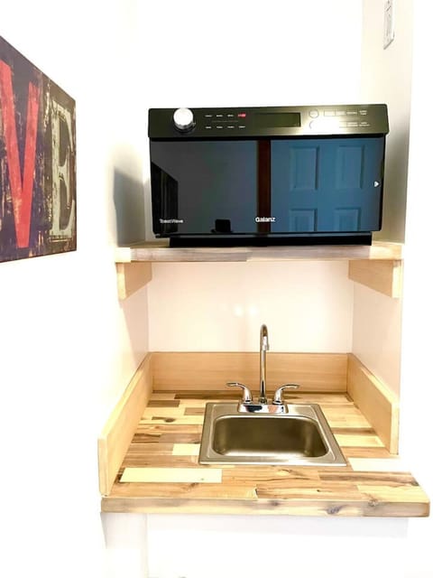 The kitchenette is equipped with a four-in-one oven and sink.