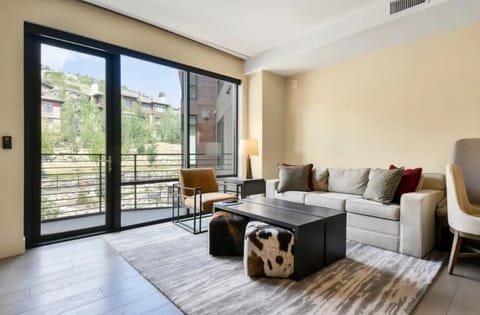 Bright living area with large windows and stylish decor.