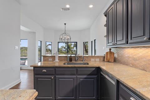 Contemporary kitchen featuring a wide island and ample counter space.