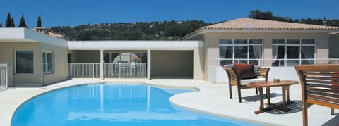 Relax and lounge by the shared outdoor pool.
