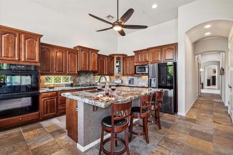 Stunning and fully equipped kitchen with stainless steel appliances and a dining table.