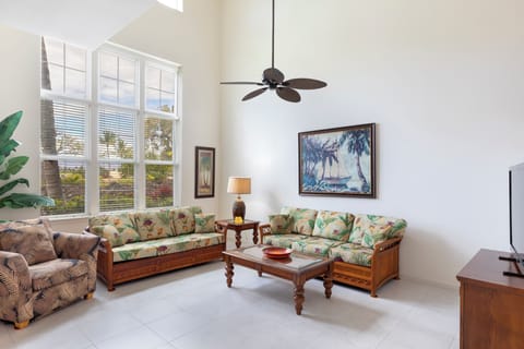 Living room with vaulted ceilings and tall windows