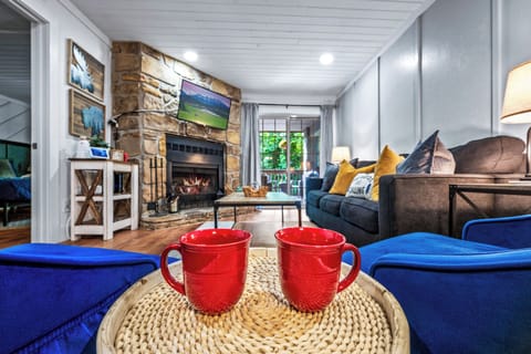 A cozy wood burning fireplace, comfortable seating, and a smart TV.