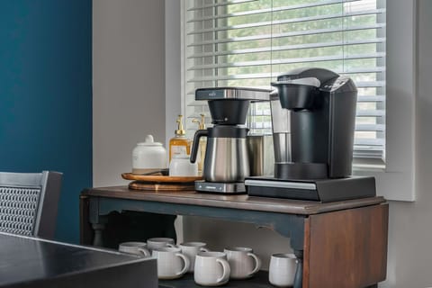 The coffee bar comes equipped with ground coffee, coffee pods, Stevia sugar packets, coffee syrups, a drip coffee maker and Keurig coffee maker