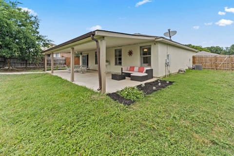 The relaxing backyard has a large covered patio with plenty of outdoor seating.