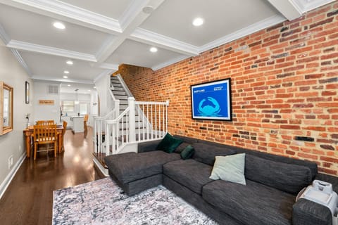 Living room with large smart TV. Couch is soft, large, and comfy from West Elm.