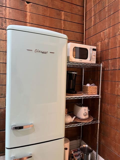 Brand new retro refrigerator and freezer, microwave, toaster, and Keurig coffee maker with coffee.