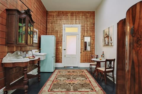 Kitchenette, original artwork, and antique marble top table with silk covered chairs.