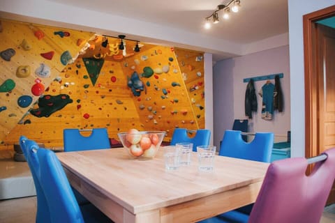 living room with dining area and climbing wall