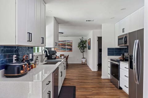 Prepare delicious meals in this stunning, fully equipped kitchen featuring sparkling quartz countertops and stainless steel appliances. With plenty of prep space and a thoughtful layout, it’s as functional as it is beautiful.