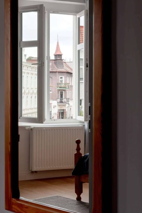 A narrow corridor with a view of the church tower.