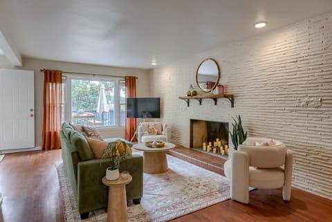 Living room with fire place, cozy couches, and TV