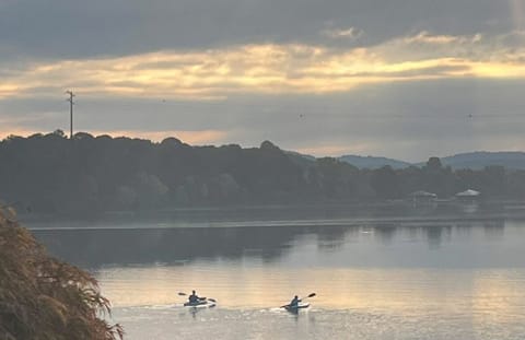 Guests enjoying a serene morning paddle around the lake on the kayaks
