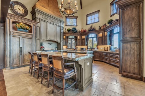 Kitchen in Luxury Park City vacation rental, marble counters, wooden shelves.