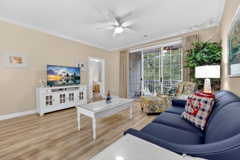 Living Room - Spacious and bright living room with plenty of seating and multiple TVs, perfect for relaxing after a day exploring North Myrtle Beach.