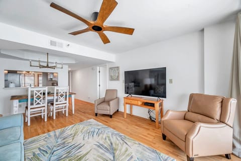 Relaxed living space w/ cozy seating, TV & warm wood floors.