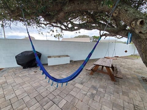 Relax in the hammock in a tranquil backyard setting, perfect for leisurely afternoons.
