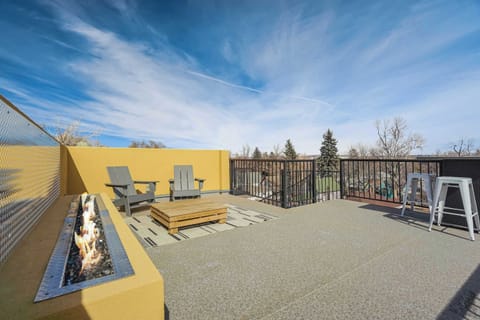 Open rooftop deck with sleek seating and a long fire feature sets the scene for breezy afternoons and glowing evenings. Stretch out under wide skies, gather around the flame, and enjoy the open-air layout framed by clean lines and city views.