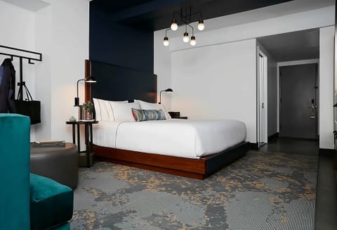Stretch out in a spacious king bed with modern lighting.