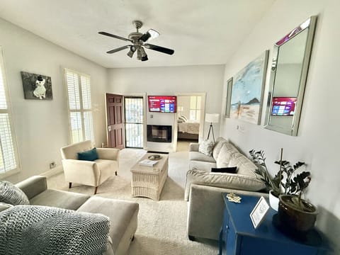 Living Room - The coffee table and chair can be moved in order to fit the queen air mattress that we provide.