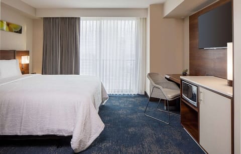 Stretch out in a serene king room with workspace nearby.