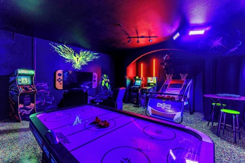 Epic X-Men arcade room with air hockey, basketball & racing games—guest favorite!