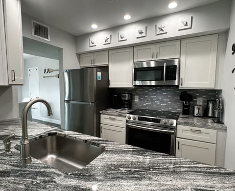 View of the beautifully renovated kitchen- fully stocked with an - View of the beautifully renovated kitchen- fully stocked with anything you could need while enjoying your trip!