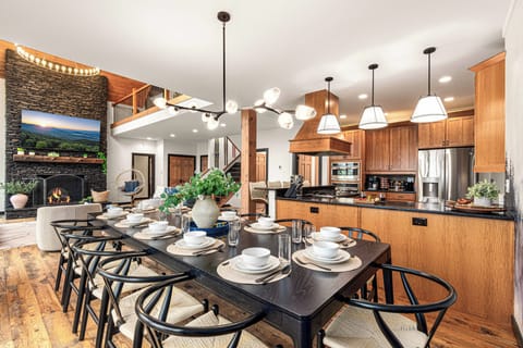 Our solid wood dining table seats 12 guests with 4 more seats nearby at the bar