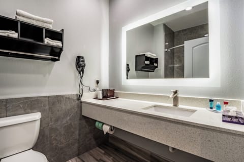 Refresh at a bright vanity with plush towels and modern sink.