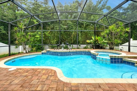 Dive into your private screened-in pool and spa