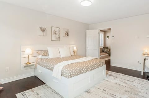 Cozy bedroom with queen bed, ensuite bathroom, soft lighting, and relaxing décor