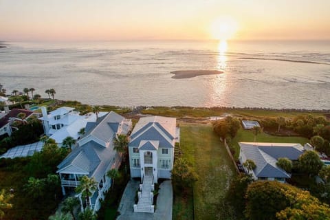 Aerial sunset view of coastal properties and sea