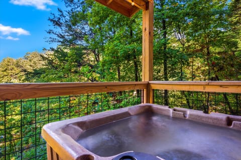 Relax in your private jacuzzi while enjoying serene views of the surrounding nature, perfect for unwinding after a day of adventure.
