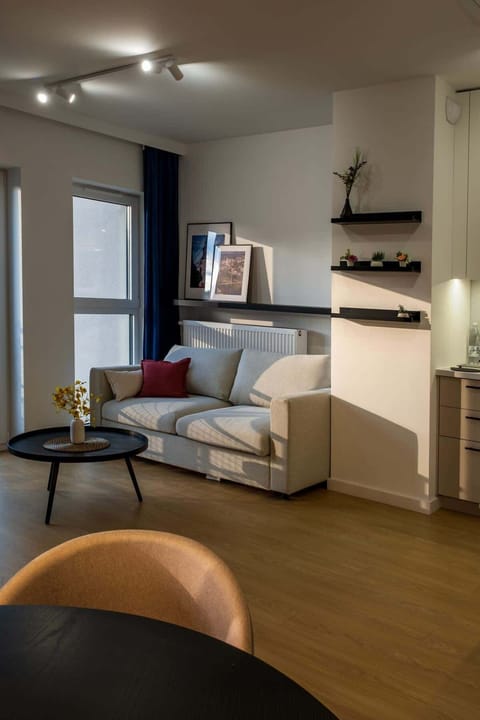 A cosy living room with a comfortable sofa and muted accents creates a warm, relaxing atmosphere.