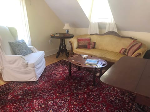 Sitting area with couch. Dining table can be used for meals or desk.