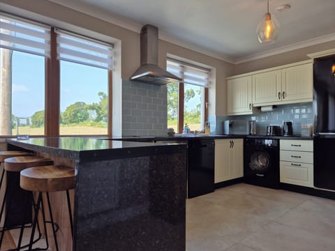 Bright, airy kitchen with stunning countryside views, plenty of space to entertain, and all the amenities for a great cooking experience!
