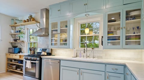 Colorful full kitchen with all the essentials including bar seating and dishwasher!