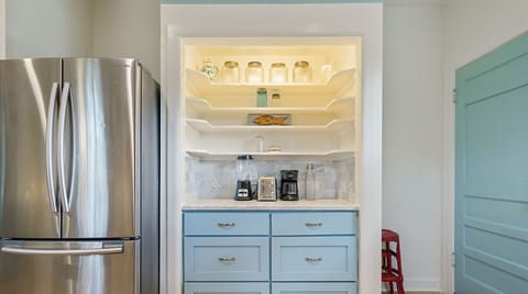 Colorful full kitchen with all the essentials including bar seating and dishwasher!