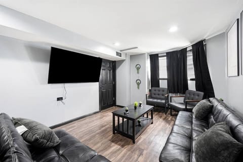 living room with 2 futons and 2 chairs - 65 inch TV