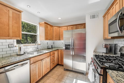 Kitchen is outfitted with new, modern stainless steel appliances. 