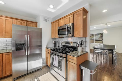 Gas range and a variety of pots, pans, baking sheets and cooking utensils.