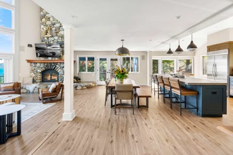 Main Floor: Open layout, kitchen, dining room, living room, soaring windows, impressive lake views