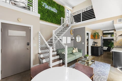 High ceilings and a Smart TV in this spacious living room off the kitchen with a dining nook for you to gather and relax.  The couch turns into a Futon to sleep on.